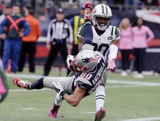 New England Patriots wide receiver Danny Amendola (80) scores a touchdown after catching a pass in front of New York Jets cornerback Marcus Williams (20) during the second half of an NFL football game, Sunday, Oct. 25, 2015, in Foxborough, Mass. (AP Photo/Charles Krupa)