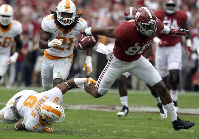 Alabama tight end O.J. Howard (88) breaks free from the tackle of Tennessee defensive back Todd Kelly Jr. (6) during the first quarter of an NCAA college football game, Saturday, Oct. 23, 2015, in Tuscaloosa, Ala. 