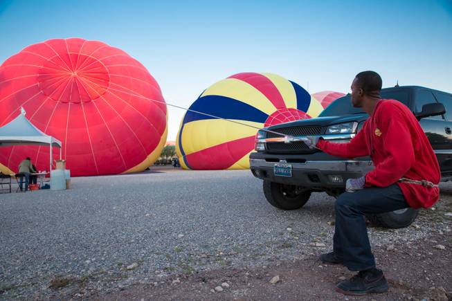 Chase crew member James L. Bush preps an 8 passenger hot air balloon for launch during the 5th annual Balloon Festival at Southern Hills Hospital, Friday Oct. 23, 2015.