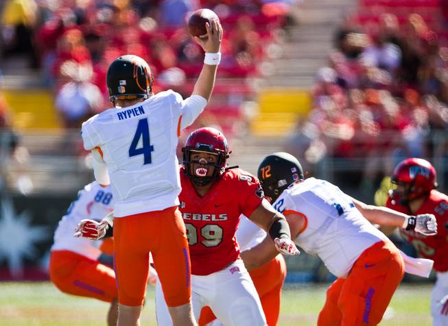 UNLV's Mike Huges Jr., 99, gets to Boise State QB Brett Rypien, 4, a bit late for a stop at during their game at Sam Boyd Stadium on Saturday, October 31, 2015.