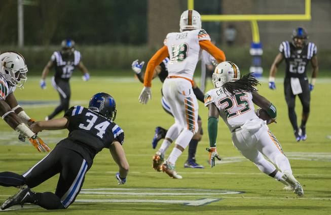Miami's Dallas Crawford (25) returns a kickoff, which featured multiple laterals before Corn Elder subsequently received the final lateral, and scored to beat Duke 30-27 in an NCAA college football game in Durham, N.C., on Saturday, Oct. 31, 2015.