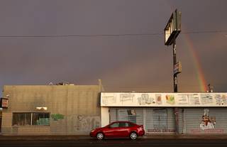 A rainbow is shown behind businesses on Main Street after a rain shower Wednesday, Nov. 4, 2015.