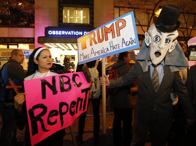 Protesters opposed to the appearance of Republican presidential candidate Donald Trump as a guest host on this weekend's "Saturday Night Live," demonstrate in front of NBC Studios where the television show is taped and broadcast, Wednesday, Nov. 4, 2015, in New York. 