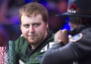 Chip leader Joe McKeehen, left, of Philadelphia, looks toward Neil Blumenfield of San Francisco during the first day of the World Series of Poker Main Event final table at the Rio Sunday, Nov. 8, 2015.