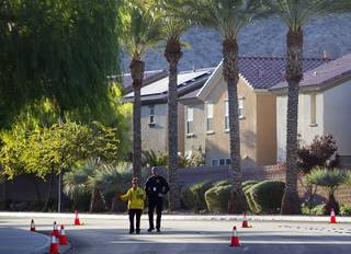 Metro Police officers investigate a shooting scene near Fort Apache Road and Huntington Cove Parkway Monday, Nov. 9, 2015.