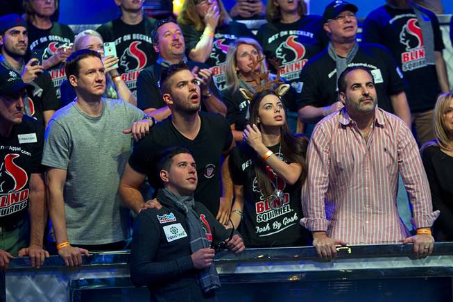Joshua Beckley, bottom, of Marlton, New Jersey waits with family and friends after going all-in against Joe McKeehen of Philadelphia during the World Series of Poker Main Event at the Rio Tuesday, November 10, 2015. McKeehen beat Beckley to win the championship bracelet and $7.68 million in prize money.