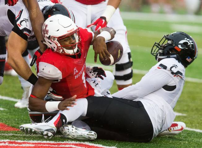 Houston's Greg Ward Jr. (1) loses the ball during the first half of an NCAA college football game at TDECU Stadium, Saturday, Nov. 7, 2015, in Houston. 