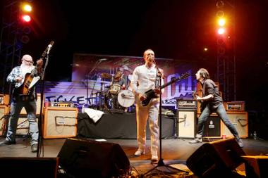 Dave Catching, Jesse Hughes and Matt McJunkins of Eagles of Death Metal perform Thursday, Oct. 15, 2015, in Los Angeles.