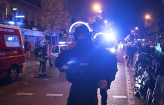 Elite police officers arrive outside the Bataclan theater in Paris, France, Wednesday, Nov. 13, 2015. Several dozen people were killed in a series of unprecedented attacks around Paris on Friday, French President Francois Hollande said, announcing that he was closing the country's borders and declaring a state of emergency.