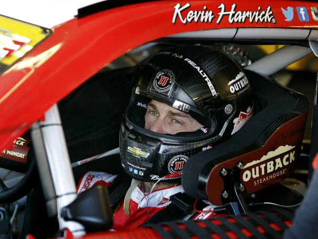 Kevin Harvick sits in his car Saturday, Nov. 14, 2015, before practice for Sunday's NASCAR Sprint Cup Series auto race at Phoenix International Raceway in Avondale, Ariz. Harvick is looking to win his fifth straight race at Phoenix and clinch a spot in the final Chase for the Cup championship race in Homestead, Fla.