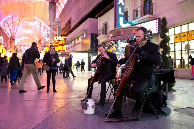 Street performers perform in a pre-designated spot on the Fremont Street Experience, Tuesday Nov. 17, 2015. A new regulation takes effect today that brings order to the chaos of street performers.