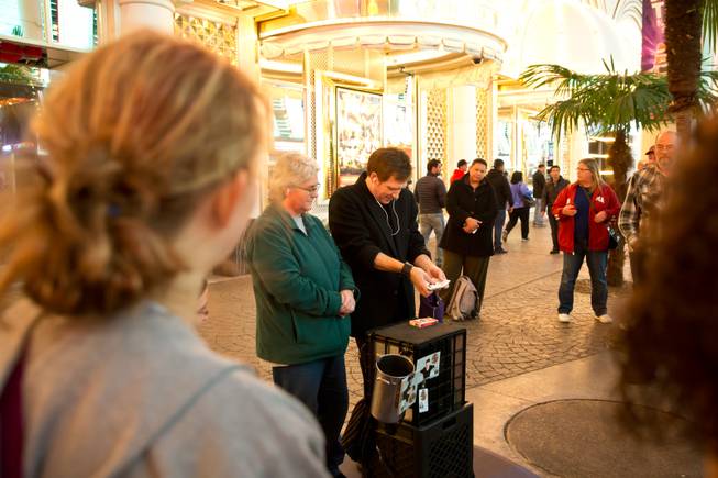 A street magician perform an illusion from a pre-designated spot on the Fremont Street Experience, Tuesday Nov. 17, 2015. A new regulation takes effect today that brings order to the chaos of street performers.