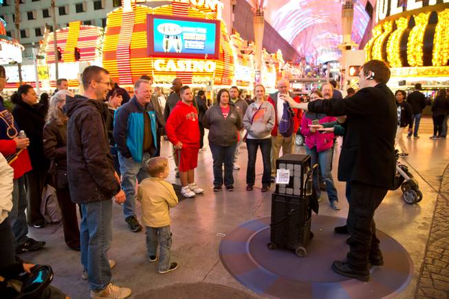 A street magician perform an illusion from a pre-designated spot on the Fremont Street Experience, Tuesday Nov. 17, 2015. A new regulation takes effect today that brings order to the chaos of street performers.