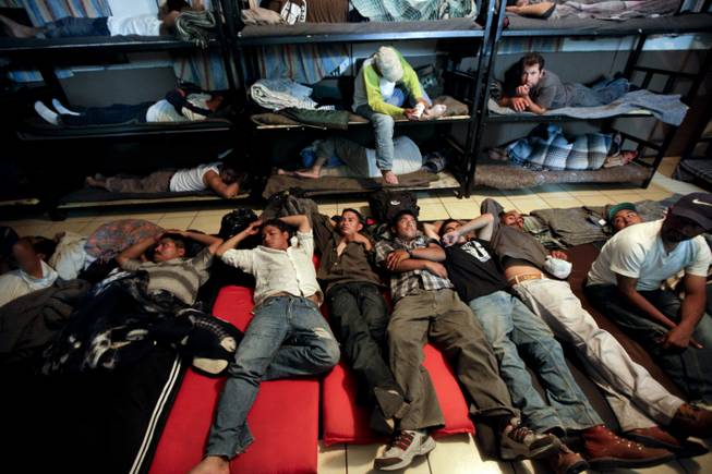 In this April 28, 2010, file photo, men look for a place to sleep in a crowded shelter for migrants deported from the United States in the border city of Nogales, Mexico. More Mexicans are leaving the United States than coming to the country, marking a reversal to one of the most significant immigration trends in U.S. history, according to a study published Thursday, Nov. 19, 2015.