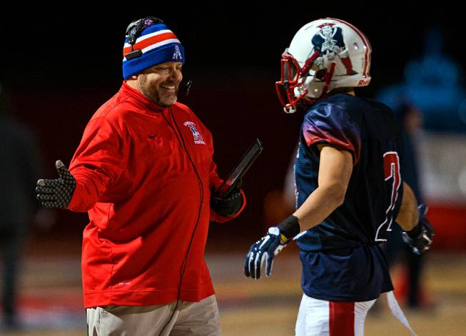 Liberty's head coach Richard Muraco congratulates player Ethan Dedeaux (2) on another score versus Green Valley during their high school state quarterfinal game at Liberty on Friday, November 20, 2015.