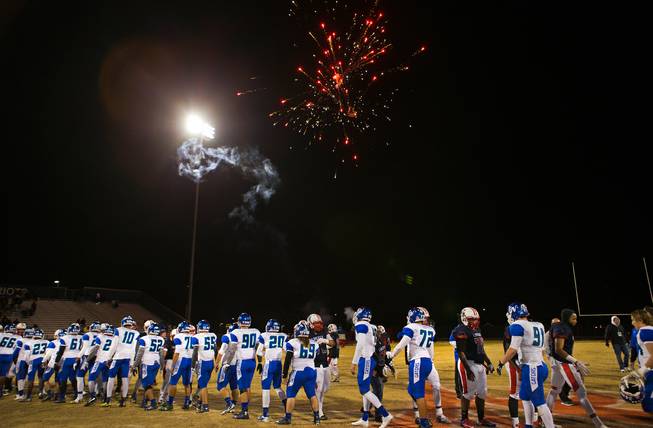 Liberty players shake the hands of Green Valley players as fireworks above help to celebrate their win in their high school state quarterfinal game at Liberty on Friday, November 20, 2015.