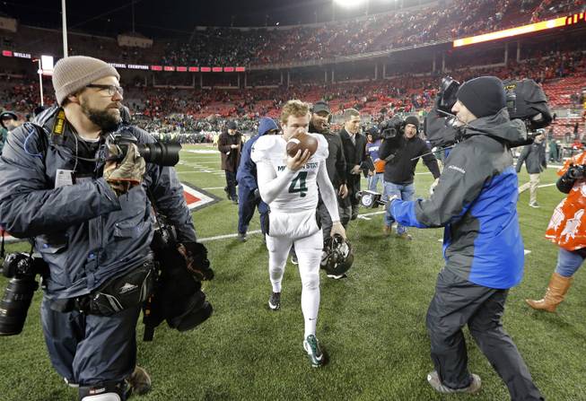 Michigan State kicker Michael Geiger (4) kisses the game ball as he walks off the field after his team's 17-14 win over Ohio State.
