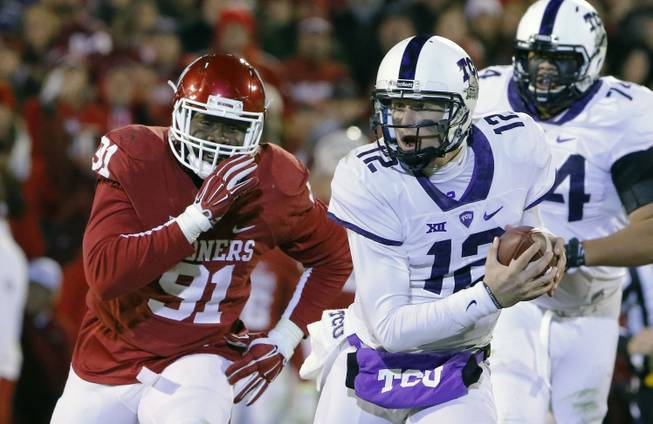 TCU quarterback Foster Sawyer (12) is chased down by Oklahoma defensive end Charles Tapper (91).