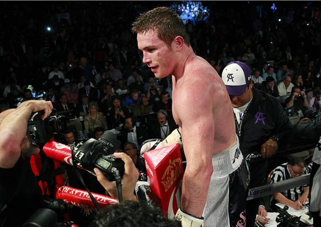 Canelo Alvarez of Mexico celebrates his victory over Miguel Cotto of Puerto Rico after their middleweight fight at the Mandalay Bay Events Center Saturday, Nov. 21, 2015.