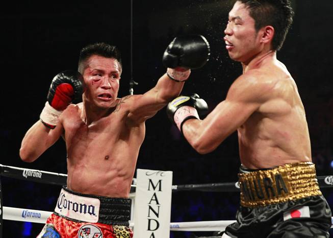 Francisco Vargas, left, of Mexico lands a punch on WBC super featherweight champion Takashi Miura of Japan during their title fight at the Mandalay Bay Events Center Saturday, Nov. 21, 2015.
