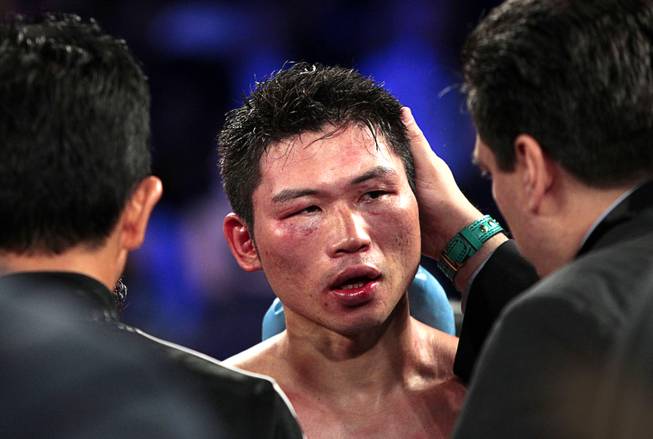 Takashi Miura of Japan is checked out after losing his WBC super featherweight title to Francisco Vargas of Mexico at the Mandalay Bay Events Center Saturday, Nov. 21, 2015. Vargas beat Miura with a 9th-round TKO.