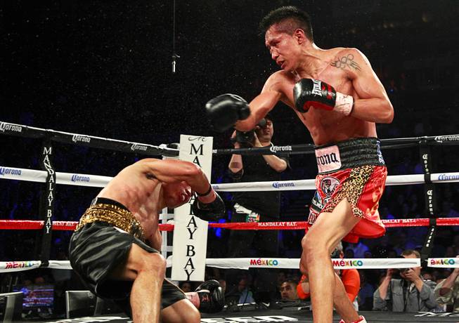 Francisco Vargas of Mexico knocks down WBC super featherweight champion Takashi Miura of Japan in the ninth round of their title fight at the Mandalay Bay Events Center Saturday, Nov. 21, 2015.
