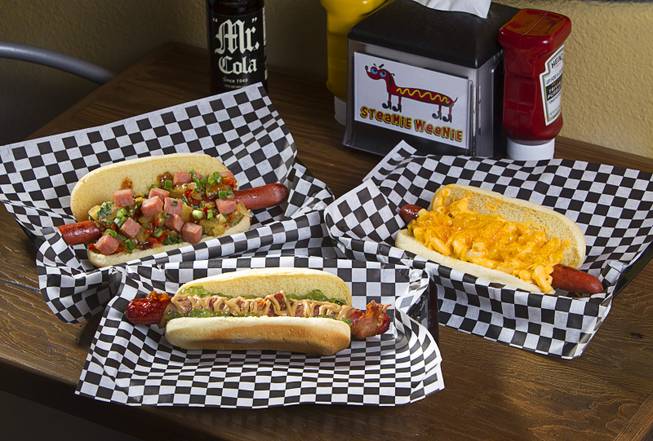 Specialty dogs at the Steamie Weenie, 1500 N Green Valley Parkway, in the Pebble Marketplace in Henderson Sunday, Nov. 22, 2015.  Clockwise from right: The Mac & Cheese & Cheese, PBB&JJ (bacon wrapped dog with peanut butter and jalapeno jelly), and the 9th Island.