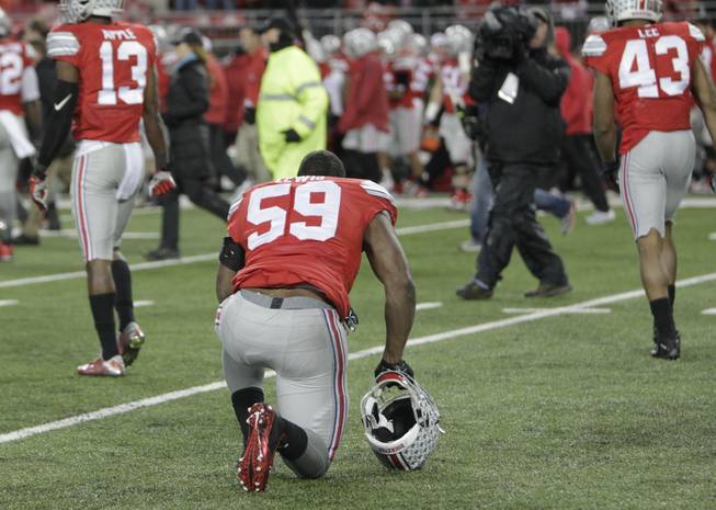 Ohio State defensive lineman Tyquan Lewis reacts after losing 17-14 win over Michigan State in an NCAA college football game, Saturday, Nov. 21, 2015, in Columbus, Ohio.