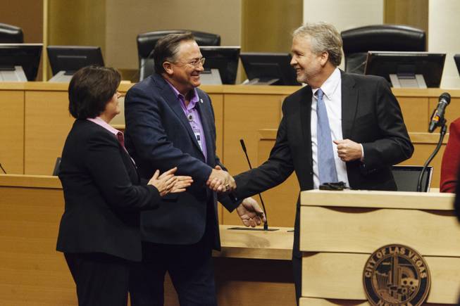 From the left, City Manager Betsy Fretwell, Mayor Pro Tem Steve Ross, and City of Las Vegas Planning Director Tom Perrigo shake hands after a press conference with NV Energy at Las Vegas City Hall on November 24, 2015..