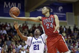 UNLV guard Jalen Poyser (24) lays the ball up as Chaminade guard Rohndell Goodwin (21) defends during the second half of an NCAA college basketball game in the second round of the Maui Invitational, Tuesday, Nov. 24, 2015, in Lahaina, Hawaii. UNLV won 93-73.