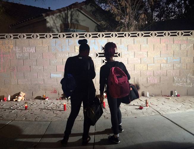 A brick wall near Mojave High School shows messages honoring Taylor Brantley, who was shot dead during an after-school fight on Friday, Nov. 20, 2015.