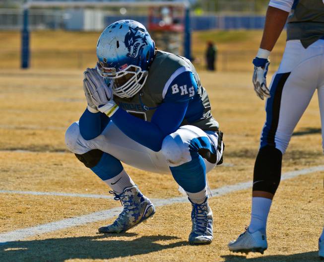 Basic's Kendahl Blakely (7) prays on the sideline as they face Liberty high school in their state semifinals football game at Basic Academy of International Studies on Saturday, November 28, 2015.