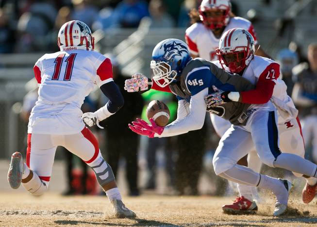 Basic's De'shawn Eagles (13) scoops up a pass under tight defense by Liberty's Jake Dedeaux (11) and Alan Mwata (22) during their high school state semifinals football game at Basic Academy of International Studies on Saturday, November 28, 2015.