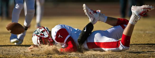 Liberty QB Kenyon Oblad (7) eats some dust following a good run and tackle versus Basic during their high school state semifinals football game at Basic Academy of International Studies on Saturday, November 28, 2015.