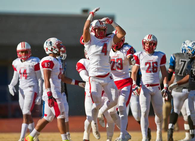Liberty's Mario Garcia (4) celebrates a "red zone" stop versus Basic during their high school state semifinals football game at Basic Academy of International Studies on Saturday, November 28, 2015.
