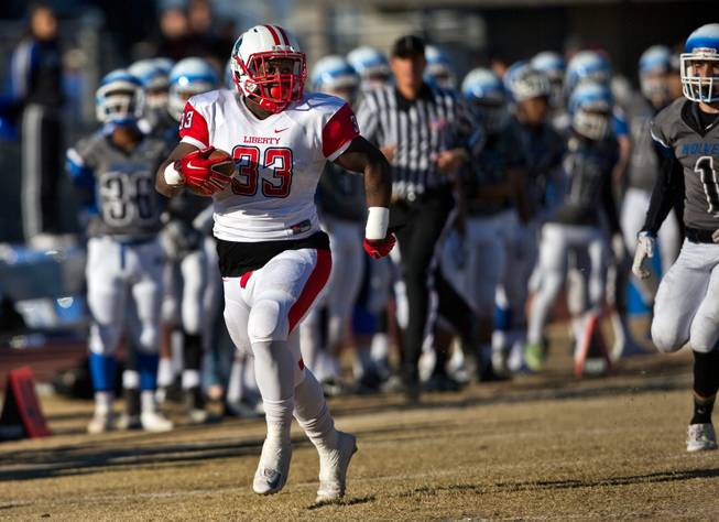 Liberty's Calvin Tubbs (33) scoots up the sideline on his way to a touchdown catch and run versus Basic during their high school state semifinals football game at Basic Academy of International Studies on Saturday, November 28, 2015.