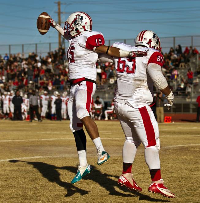 Liberty's Stephon Stowers (15) celebrates another score with teammate Tyus Toomalatai (65) over Basic during their high school state semifinals football game at Basic Academy of International Studies on Saturday, November 28, 2015.