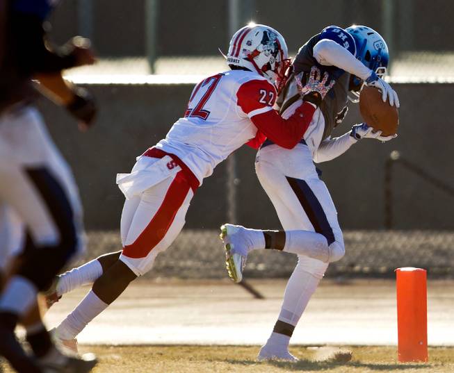 Basic's Deondre Ishman (6) grabs a touchdown pass over Liberty's Alan Mwata (22) during their high school state semifinals football game at Basic Academy of International Studies on Saturday, November 28, 2015.