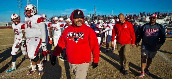 Liberty head coach Rich Muraco smiles wide walking onto the field after defeating Basic in their high school state semifinals football game at Basic Academy of International Studies on Saturday, November 28, 2015.