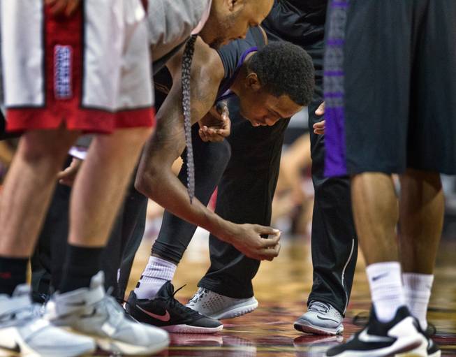 A Prairie View player luckily finds his dropped contact on the court at the Thomas & Mack Center on Saturday, November 28, 2015.