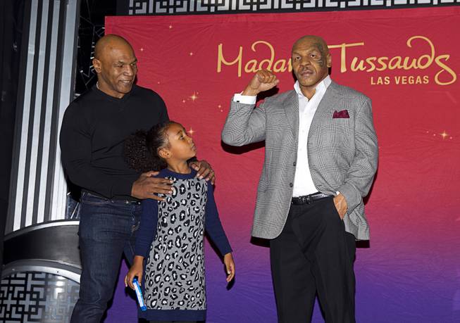 Former heavyweight boxing champion Mike Tyson and his daughter Milan, 6, look over the world's first Mike Tyson wax figure during the figure's unveiling Tuesday, Dec. 1, 2015, at Madame Tussauds Las Vegas. The figure is modeled after Tyson’s appearance as himself in “The Hangover.” The figure will be permanently displayed inside the attraction’s “The Hangover Experience” exhibit.