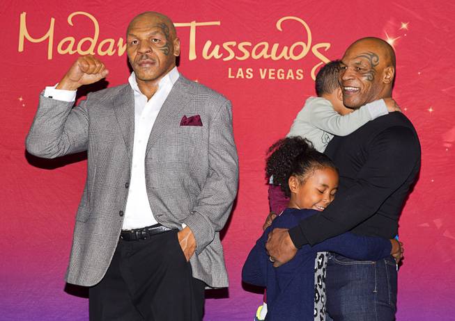 Former heavyweight boxing champion Mike Tyson, right, his daughter Milan, 6, and son Morocco, 4, stand with the world's first Mike Tyson wax figure during the figure's unveiling Tuesday, Dec. 1, 2015, at Madame Tussauds Las Vegas. The figure is modeled after Tyson’s appearance as himself in “The Hangover.” The figure will be permanently displayed inside the attraction’s “The Hangover Experience” exhibit.