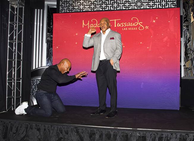 Former heavyweight boxing champion Mike Tyson bows down before the world's first Mike Tyson wax figure during the figure's unveiling Tuesday, Dec. 1, 2015, at Madame Tussauds Las Vegas. The figure is modeled after Tyson’s appearance as himself in “The Hangover.” The figure will be permanently displayed inside the attraction’s “The Hangover Experience” exhibit.