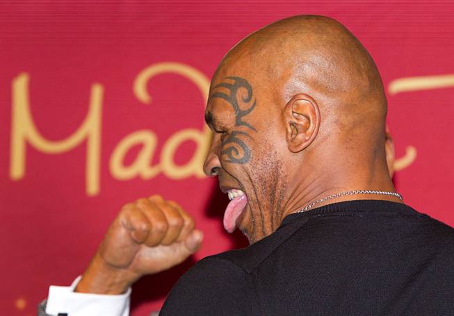 Former heavyweight boxing champion Mike Tyson sticks out his tongue during the world’s first Mike Tyson wax figure unveiling Tuesday, Dec. 1, 2015, at Madame Tussauds Las Vegas. The figure is modeled after Tyson’s appearance as himself in “The Hangover.” The figure will be permanently displayed inside the attraction’s “The Hangover Experience” exhibit.
