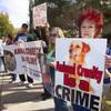 Stacia Newman, right, president of Nevada Political Action For Animals, protests in front of the Boulder City Police Department in Boulder City Thursday, Dec. 3, 2015. Protesters want charges to be brought against the city's former animal shelter supervisor for killing too many animals.