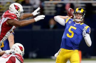 St. Louis Rams quarterback Nick Foles, right, throws under pressure from Arizona Cardinals defensive end Calais Campbell, left, during the second quarter of an NFL football game on Sunday, Dec. 6, 2015, in St. Louis. (AP Photo/Tom Gannam)