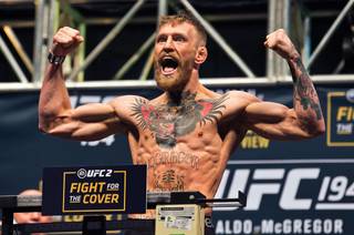UFC featherweight interim titleholder Conor McGregor flexes and yells during UFC 194 weigh-ins Friday, Dec. 11, 2015, at MGM Grand Garden Arena.
