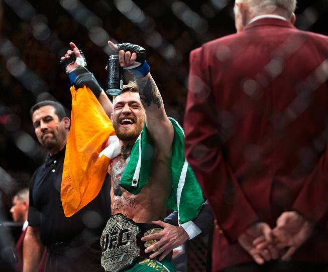 New UFC featherweight champion Conor McGregor celebrates with his new ...