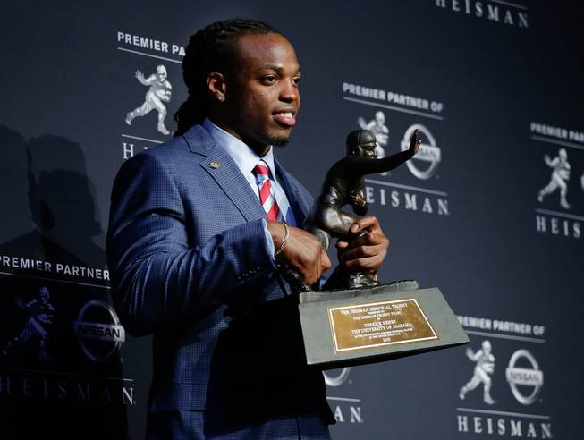 Alabama's Derrick Henry stands for photos after winning the Heisman Trophy on Saturday, Dec. 12, 2015, in New York.