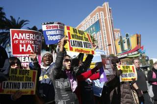 Protestors gather outside the Venetian Hotel & Casino before the CNN Republican presidential debate on Tuesday, Dec. 15, 2015, in Las Vegas.